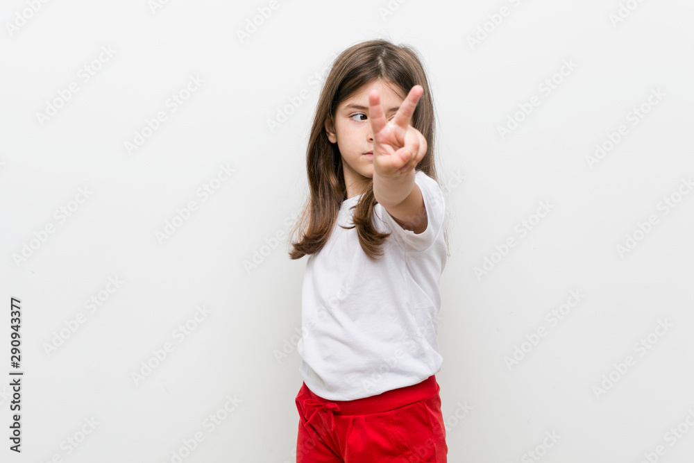 Little caucasian girl showing number two with fingers. Little caucasian girl showing number two with fingers.