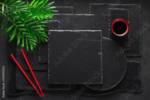 Chopsticks and bamboo bowl on black rock slate plate