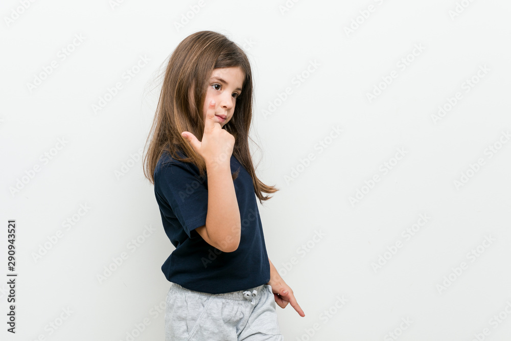 Cute little caucasian girl pointing with finger at you as if inviting come closer. Cute little caucasian girl pointing with finger at you as if inviting come closer.