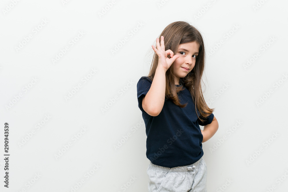 Cute little caucasian girl cheerful and confident showing ok gesture. Cute little caucasian girl cheerful and confident showing ok gesture.