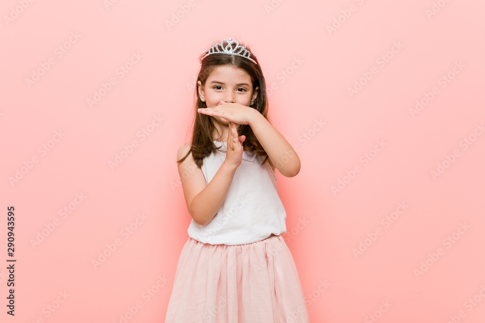 Little girl wearing a princess look showing a timeout gesture.