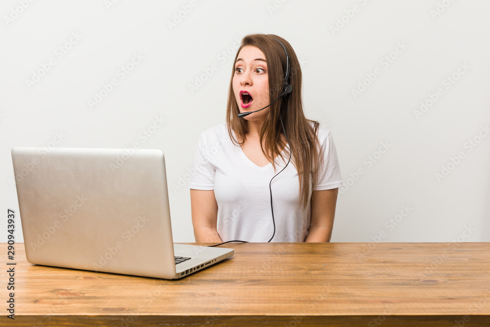 Young telemarketer woman being shocked because of something she has seen.