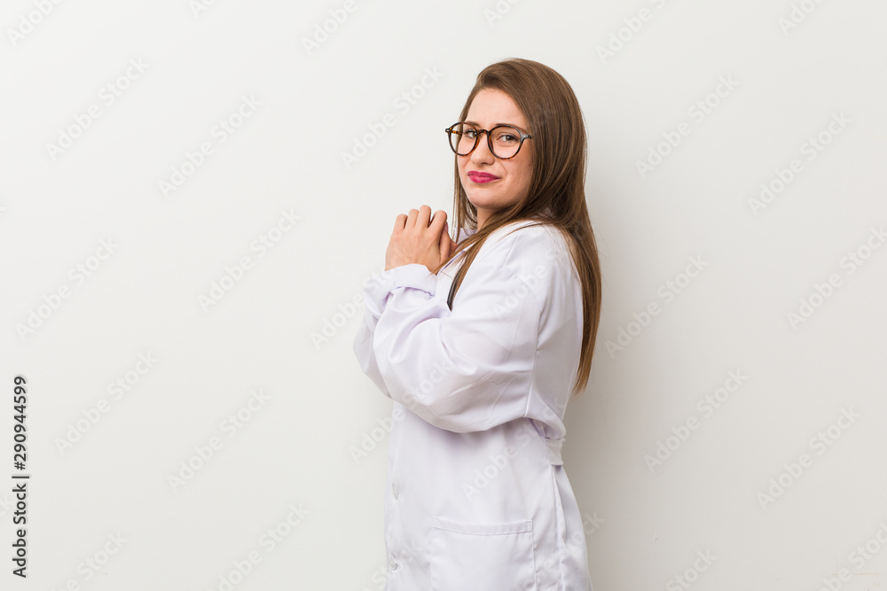 Young doctor woman against a white wall scared and afraid. Young doctor woman against a white wall scared and afraid.