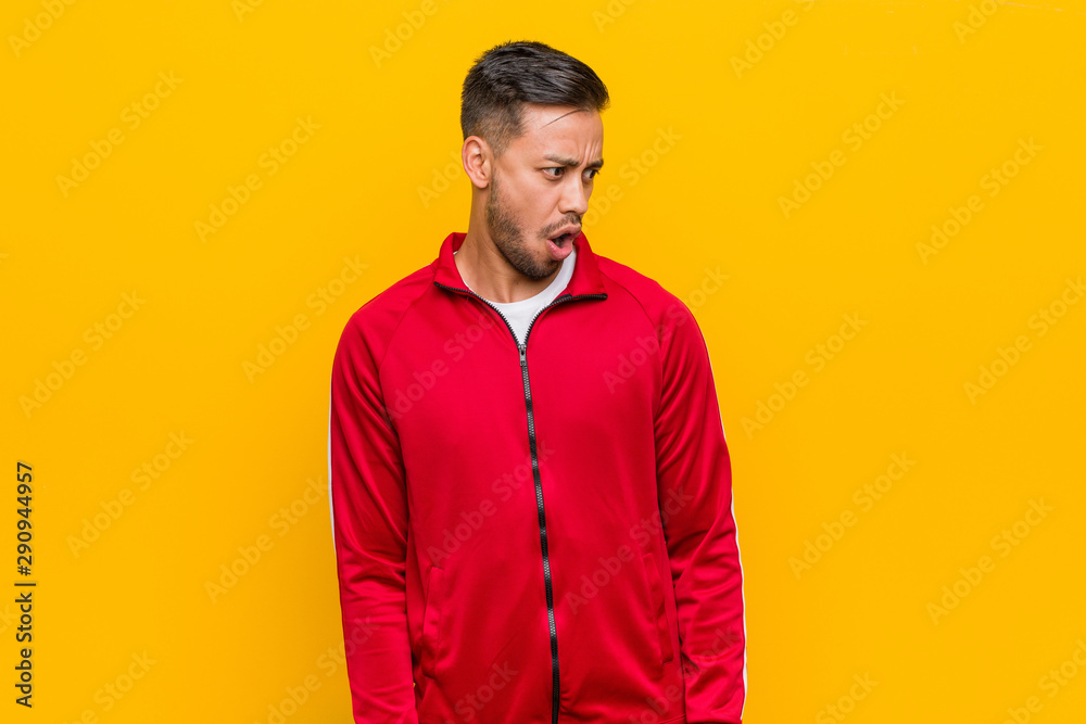 Young filipino fitness man being shocked because of something she has seen. Young filipino fitness man being shocked because of something she has seen.