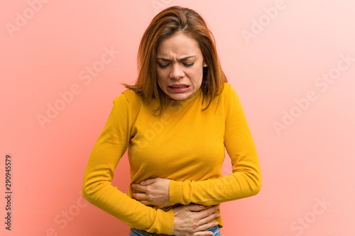 Young pretty young woman sick, suffering from stomachache, painful disease concept.