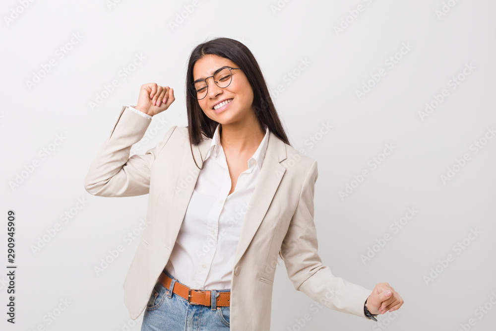 Young business arab woman isolated against a white background dancing and having fun. Young business arab woman isolated against a white background dancing and having fun.