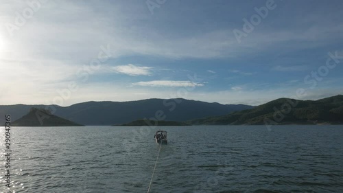 Boat Ride  At Bhumibol Dam Tak Province In Thailand. View of boat sail along river in dam on a sunny day and  beautiful mountain landscape .