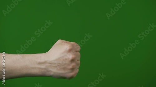 Striking with fist of hand. Kick jab strike on green screen. Boxing martial art buisiness sign victory. Attack fist. photo