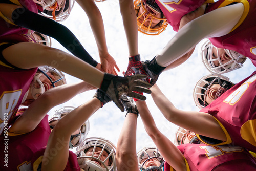 Picture of female rugby players stacking their hands together