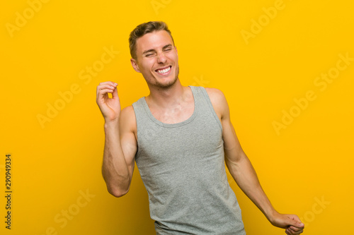 Young caucasian sport man dancing and having fun.