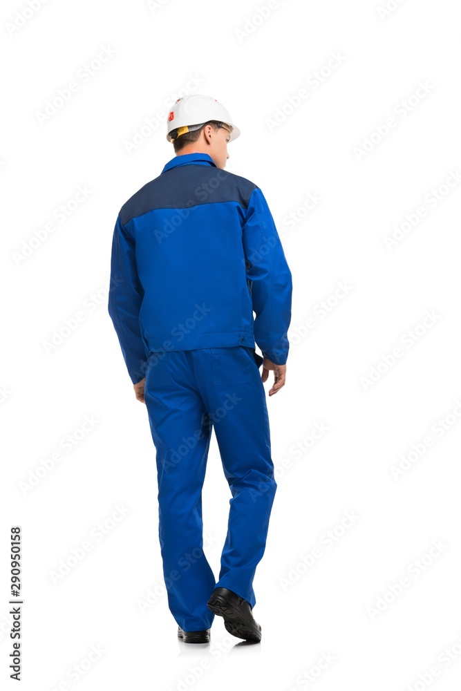 Man in blue work clothes and helmet isolated view Man in blue work clothes and helmet isolated view