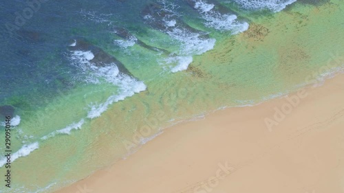 Wallpaper Mural Aerial shot of a beautiful tropical beach during low tide with big waves in blue and green water with reef and coral Torontodigital.ca