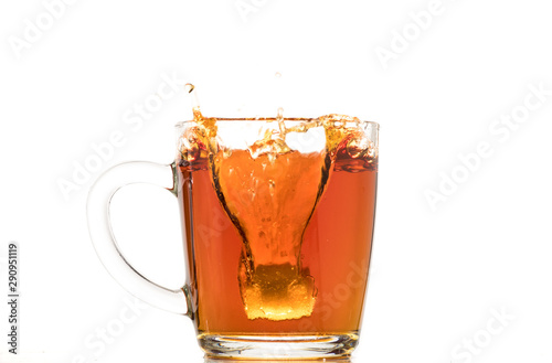making black tea from a bag with sugar in motion on a white background