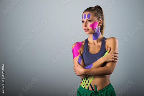 Portrait of sports woman. kinesio therapeutic tape glued to the body photo