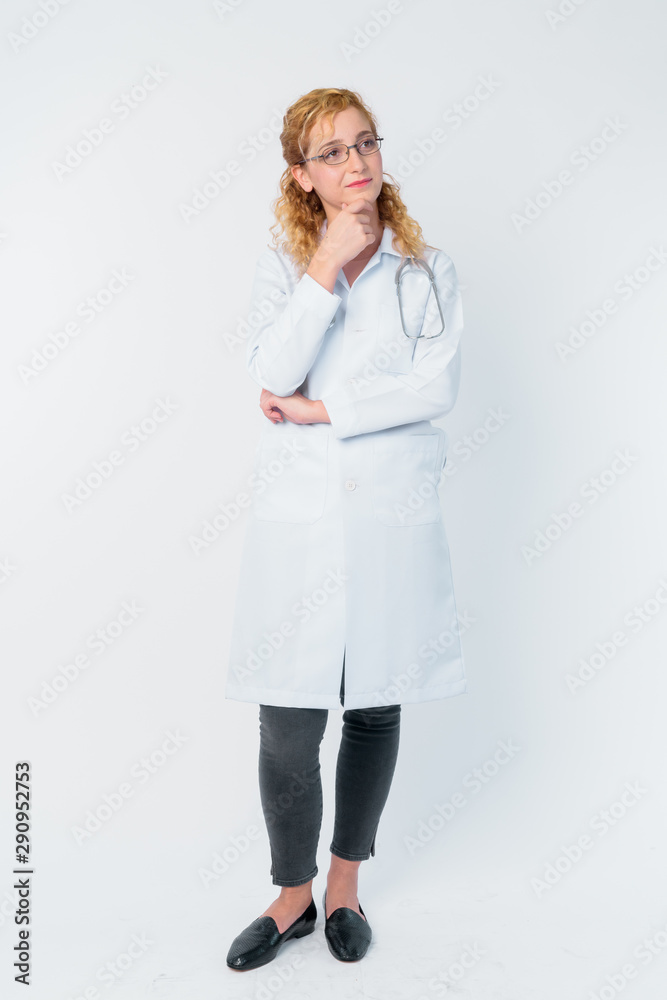 Full body shot of beautiful blonde woman doctor thinking and looking up Full body shot of beautiful blonde woman doctor thinking and looking up