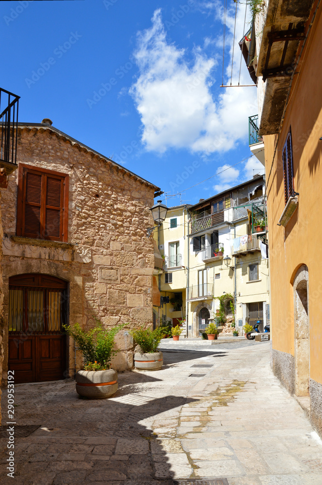 Obraz premium A narrow street between squares, monuments and colorful buildings in the town of Isernia, in Italy