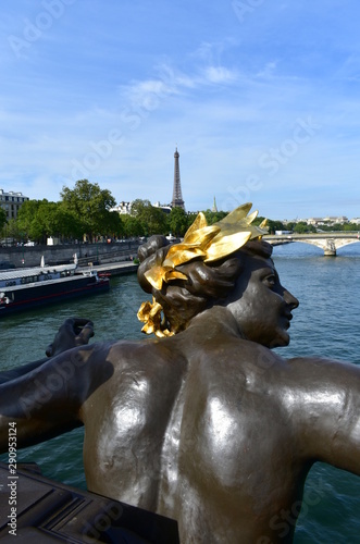 Pont Alexandre III detail, bronze sculpture close-up and Tour Eiffel. Paris, France.