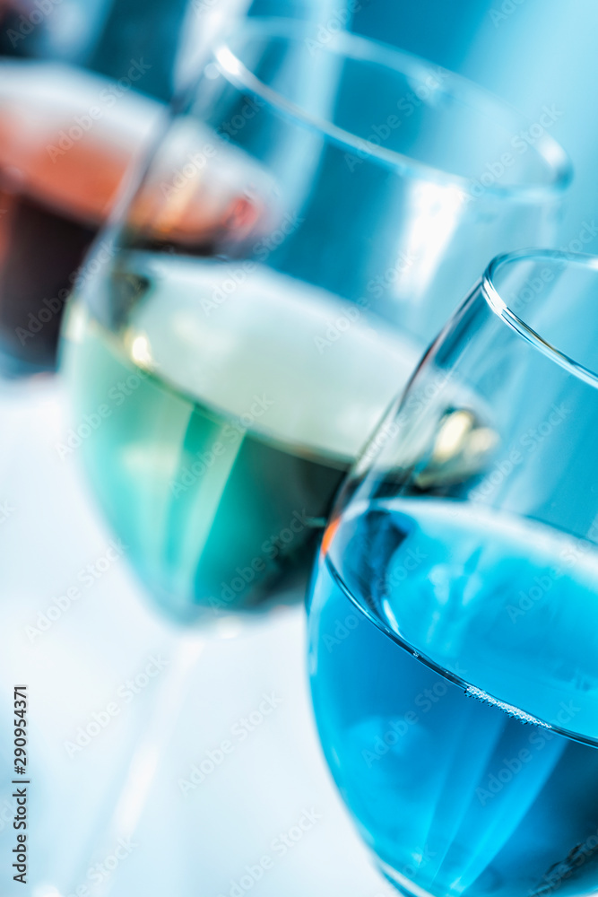 Wine Varieties. Four Glasses of Wine on Table – Red Wine, Rose, White and Blue Wine Wine Varieties. Four Glasses of Wine on Table – Red Wine, Rose, White and Blue Wine