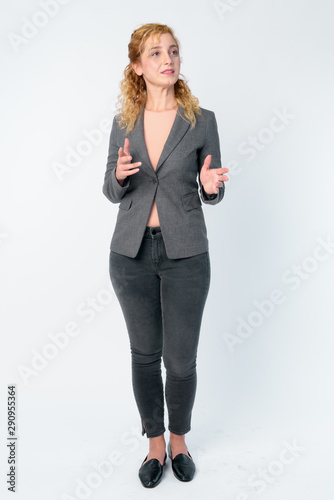 Full body shot of beautiful blonde businesswoman explaining something