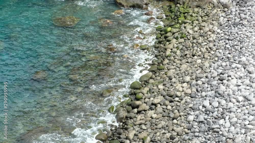 ocean waves on pebble stone beach - sea waves on pebbles ocean waves on pebble stone beach - sea waves on pebbles