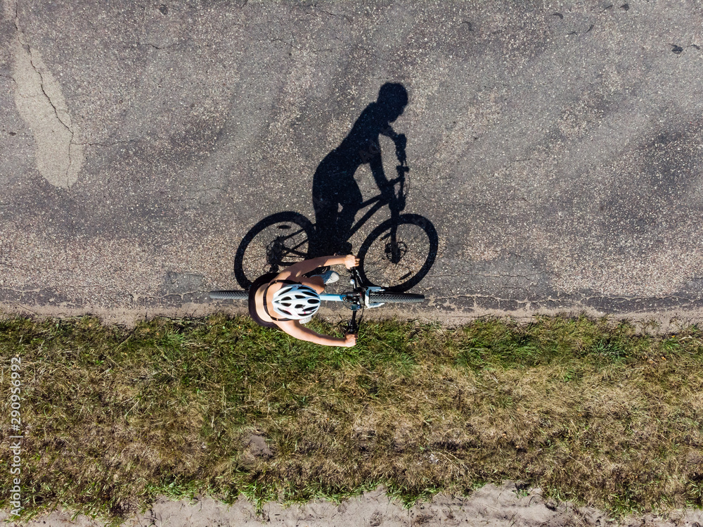 Cyclist on the road, top down image of shadow on the road Cyclist on the road, top down image of shadow on the road