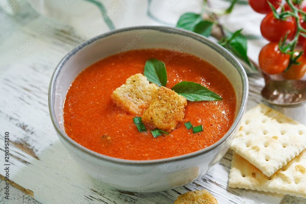Homemade creamy Tomao Soup served in a bowl, selective focus