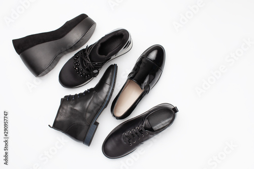 Different black leather women autumn shoes on white background