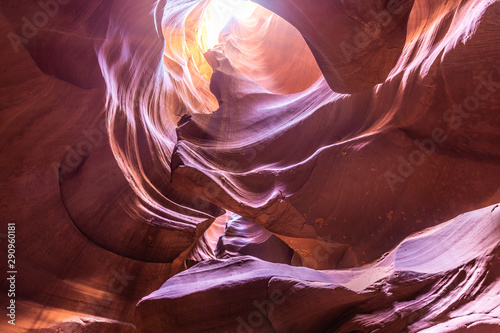 Wide angle view of the vault of the Upper Antelope Canyon with a light beam shining from an opening