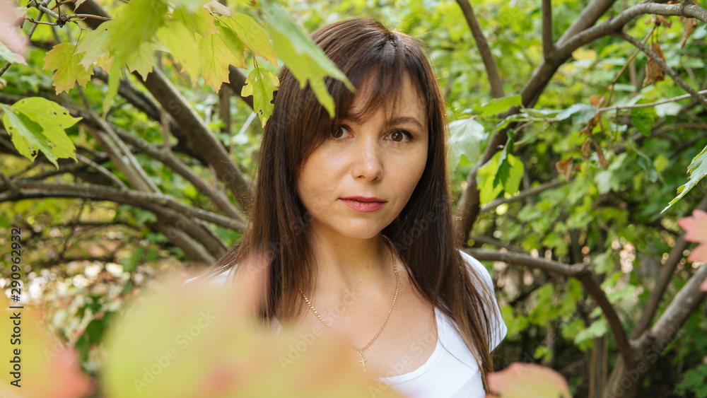 A handsome woman posing in an autumn Park. A handsome woman posing in an autumn Park.