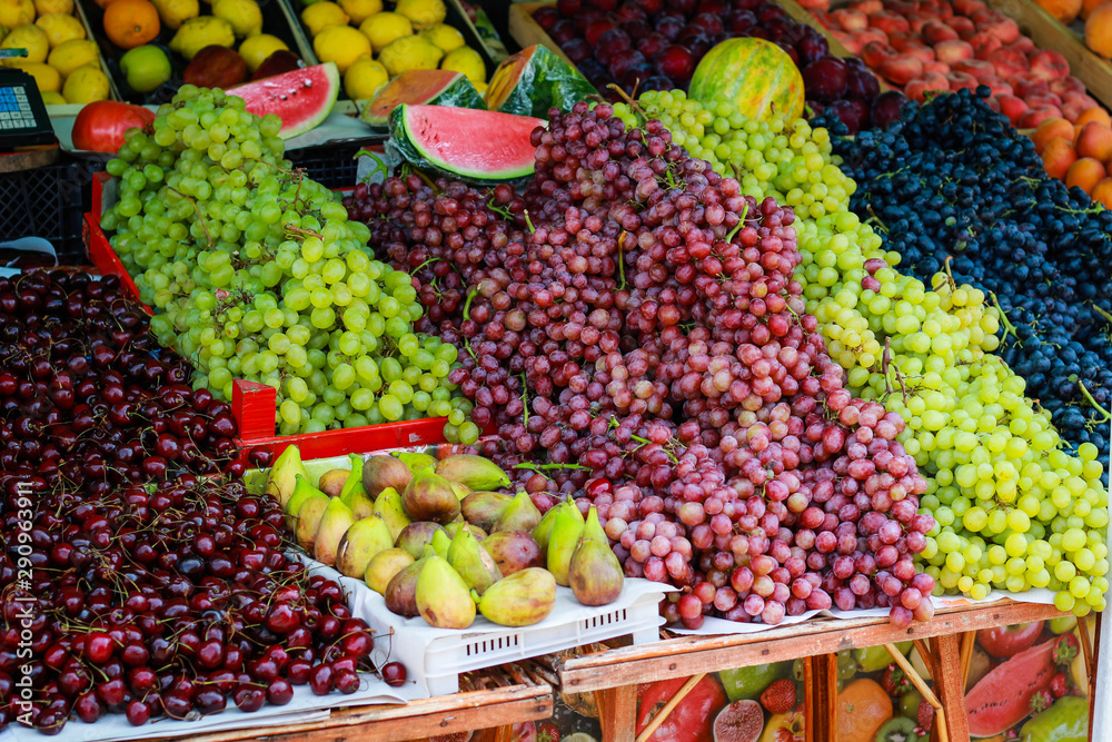 Berries in the market.Fruit tray on the street. Street food. Raspberries, blueberries, grapes. Golden Sands. Bulgaria