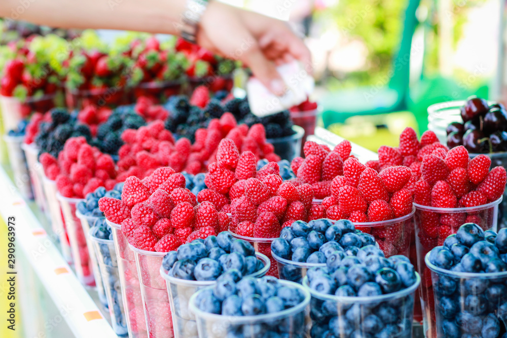 Berries in the market.Fruit tray on the street. Street food. Raspberries, blueberries, grapes. Golden Sands. Bulgaria