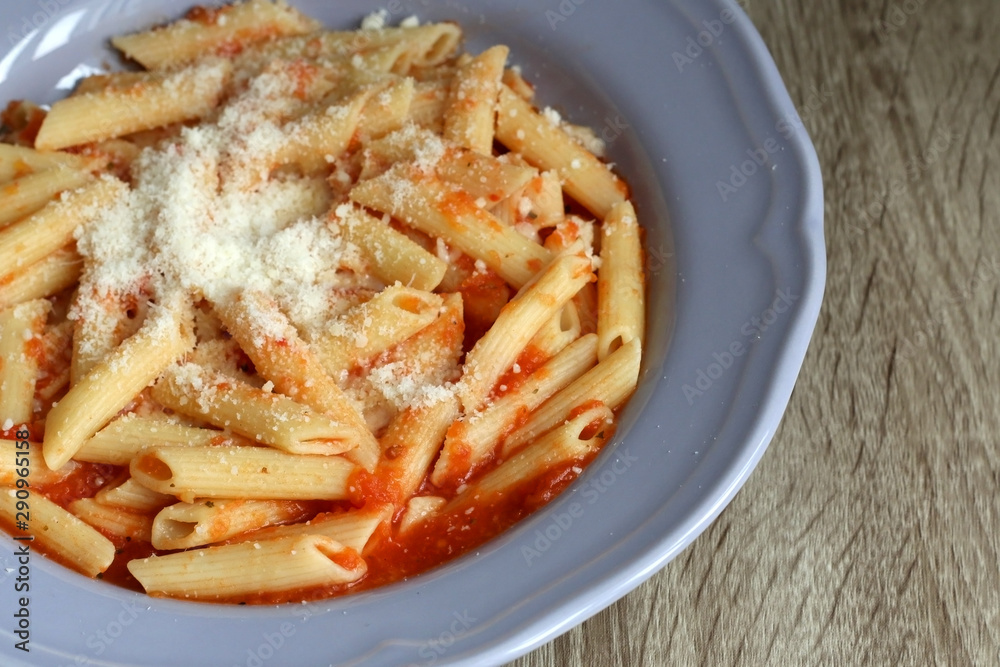 Plate of pasta with homemade tomato sauce. and grated parmesan cheese on top. Selective focus. Plate of pasta with homemade tomato sauce. and grated parmesan cheese on top. Selective focus.
