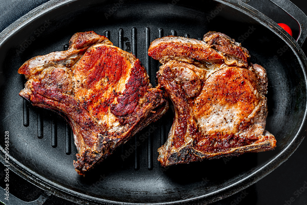Fresh juicy steak on the grill pan. Beautiful food background Fresh juicy steak on the grill pan. Beautiful food background