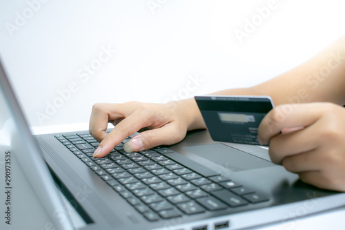 Close Up Of A woman's hand Shopping Online Using Laptop With Credit Card