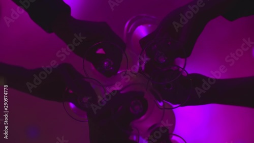 Clinking glasses with wine and toasting in club, slow motion and close up.