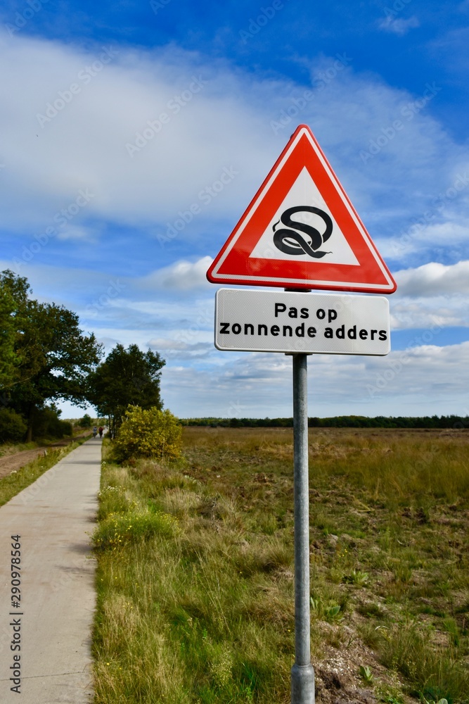 Warning sign on the heath: beware of sunning adders Warning sign on the heath: beware of sunning adders
