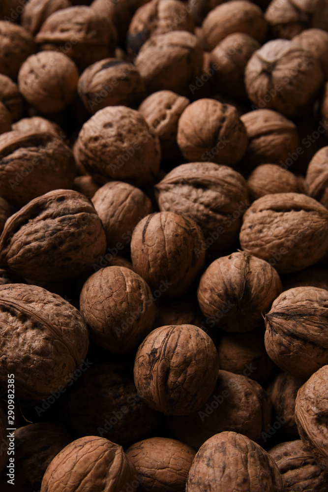 Background of fresh walnuts a lot of relief, closed, in a shell (background, pattern) from a close distance with full frame, copy space and place for text Background of fresh walnuts a lot of relief, closed, in a shell (background, pattern) from a close distance with full frame, copy space and place for text