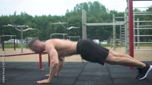 Young and muscular man during his workout on the street