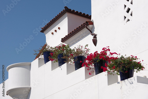 Low angle sectional outside view of the staircase of a public downtown parking structure in the typical Spanish heritage style of Santa Barbara on a bright summer day