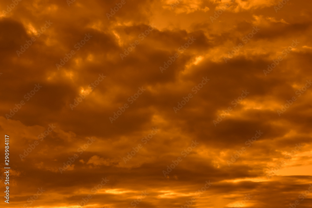 The sky at sunset. Cumulus clouds lit by the rays of the setting sun. The sky at sunset. Cumulus clouds lit by the rays of the setting sun.