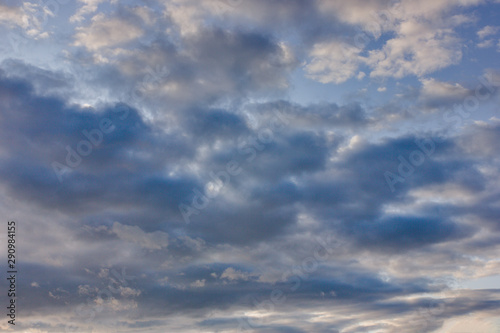 The sky at sunset. Cumulus clouds lit by the rays of the setting sun.