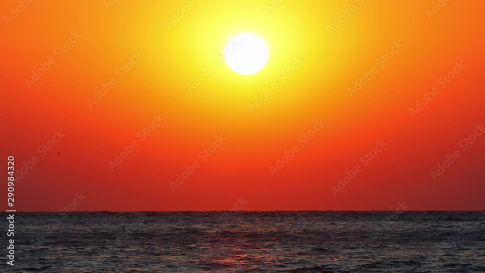 Sun over the horizon. Dramatic sunrise over sea waves Sun over the horizon. Dramatic sunrise over sea waves