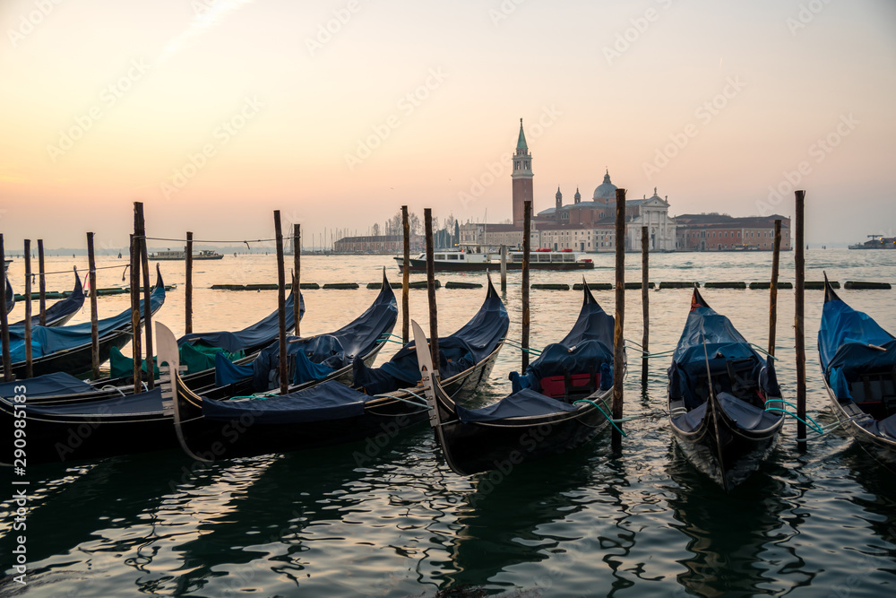 Sunrise at Venice with gondola and island of st george view from the square San marco