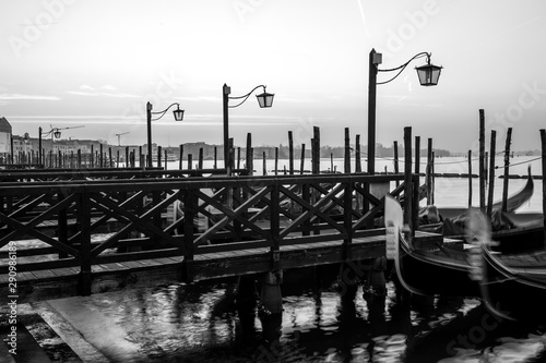 Gondolas by Saint Mark square at sunrise, Venice, Ita B&Wly