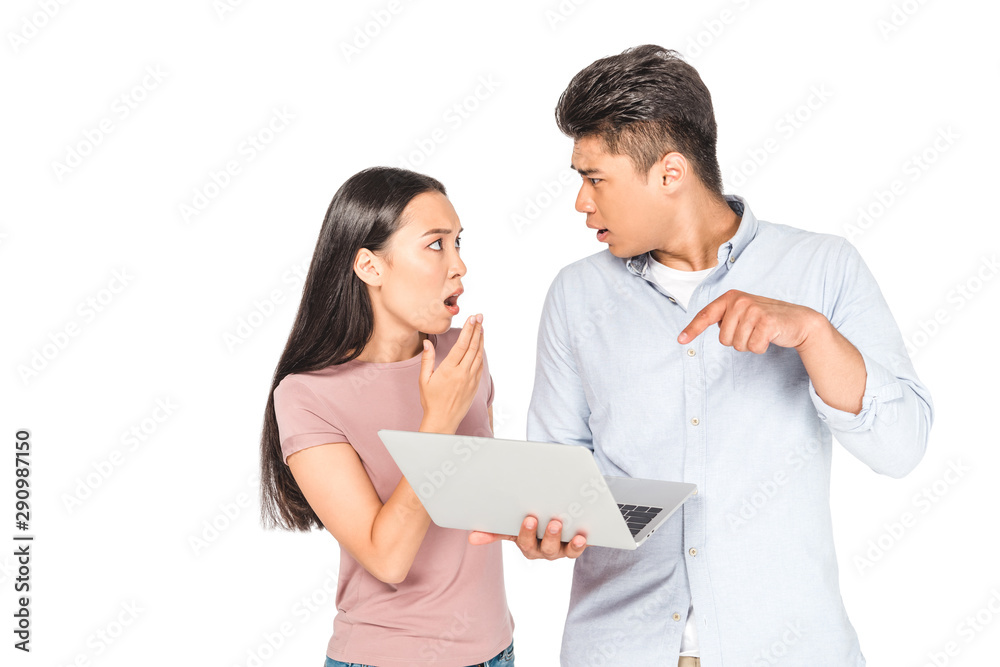 shocked asian man woman gesturing and looking at each other while using laptop isolated on white shocked asian man woman gesturing and looking at each other while using laptop isolated on white