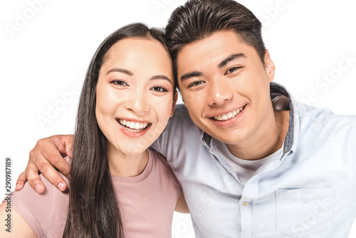 young, happy asian couple smiling at camera isolated on white