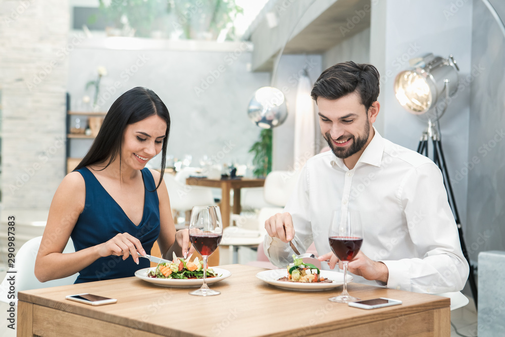 Young Man and Woman Sitting in the Restaurant Concept Young Man and Woman Sitting in the Restaurant Concept