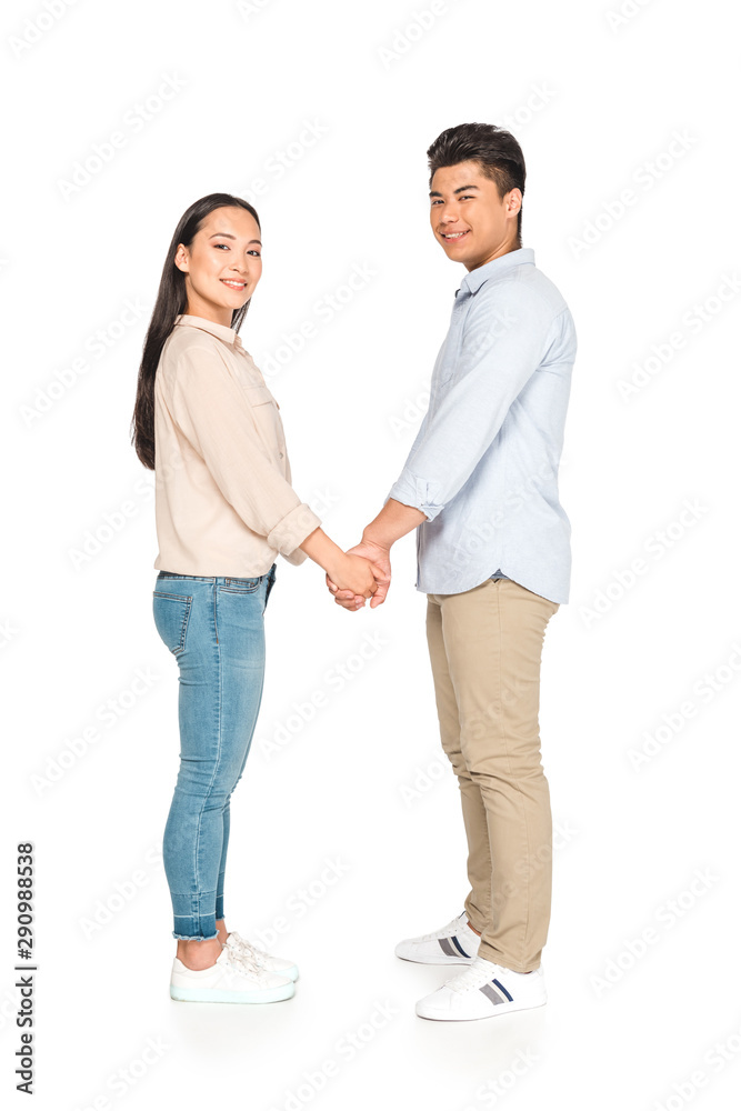 happy asian couple holding hands and smiling at camera on white background happy asian couple holding hands and smiling at camera on white background