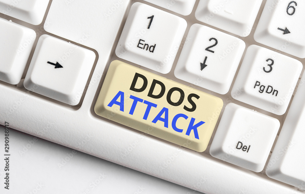 Text sign showing Ddos Attack. Business photo showcasing perpetrator seeks to make network resource unavailable White pc keyboard with empty note paper above white background key copy space Text sign showing Ddos Attack. Business photo showcasing perpetrator seeks to make network resource unavailable White pc keyboard with empty note paper above white background key copy space
