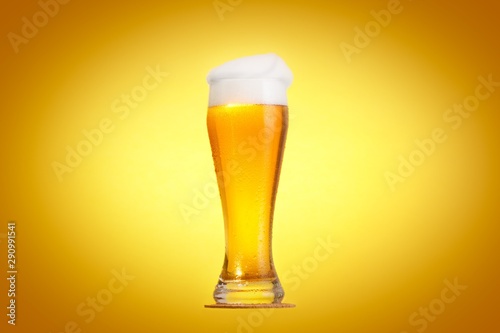 Golden beer in glass with f...